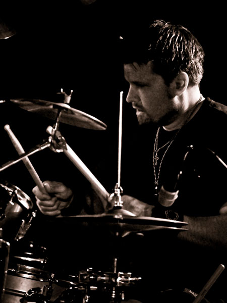 Ryan Rothmeyer playing drums at gig